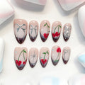medium length brown almond press on nails with cherry and bow design