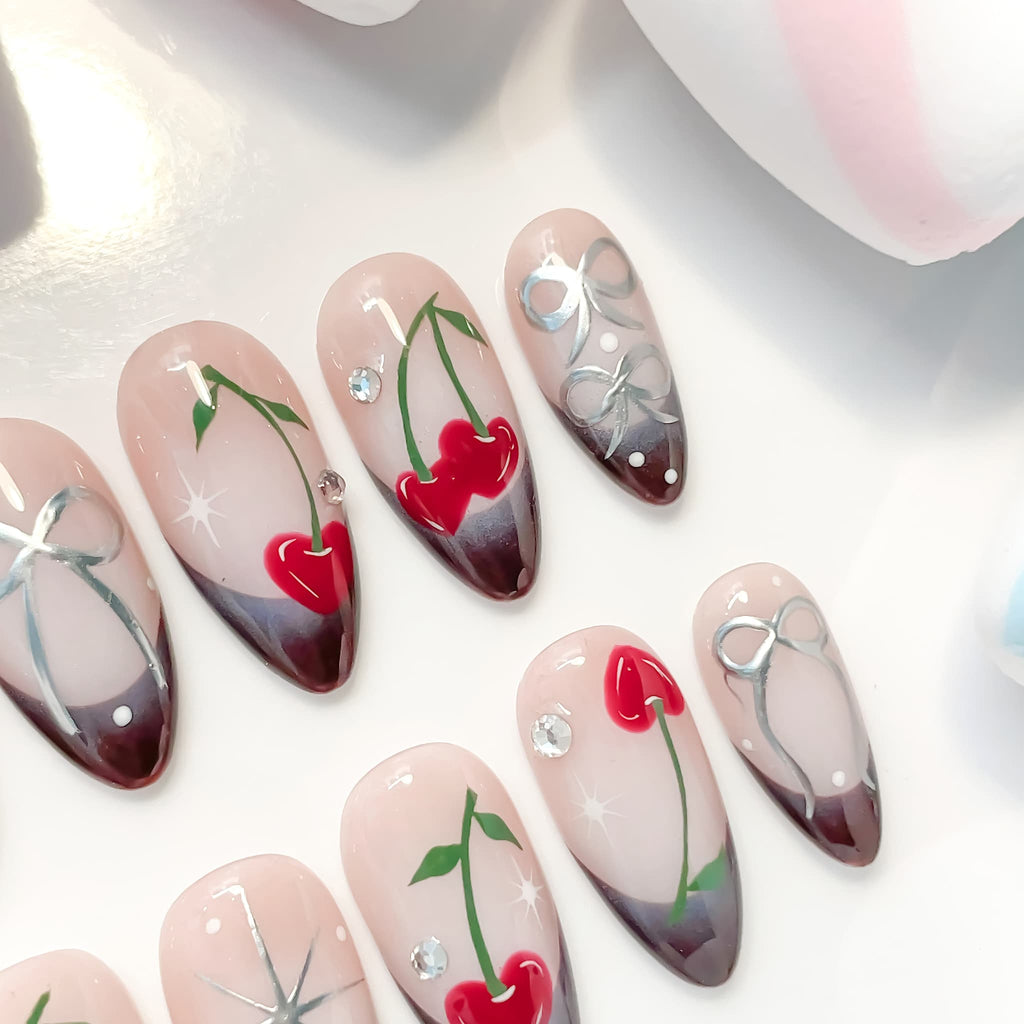 medium length brown almond press on nails with cherry and bow design