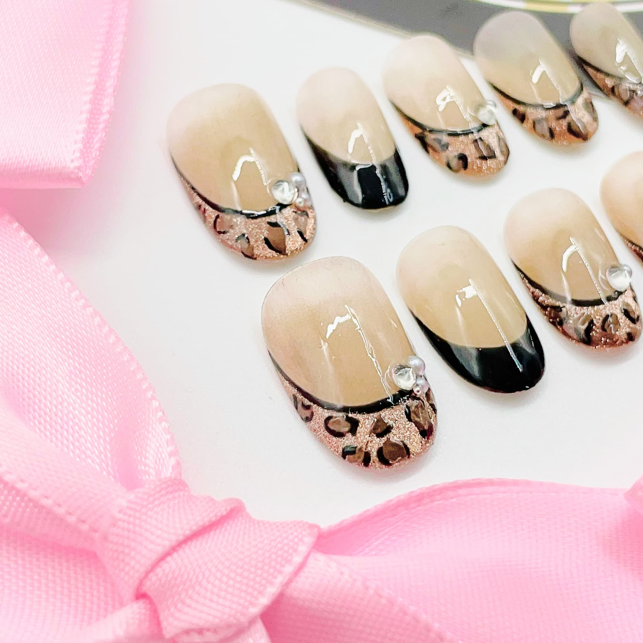 Set of nail art designs with leopard print patterns