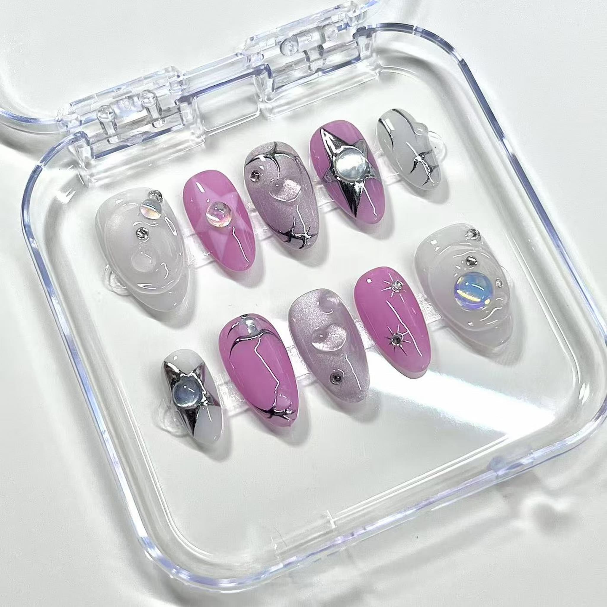 celestial pink chrome short almond press on nails with swirls and stars