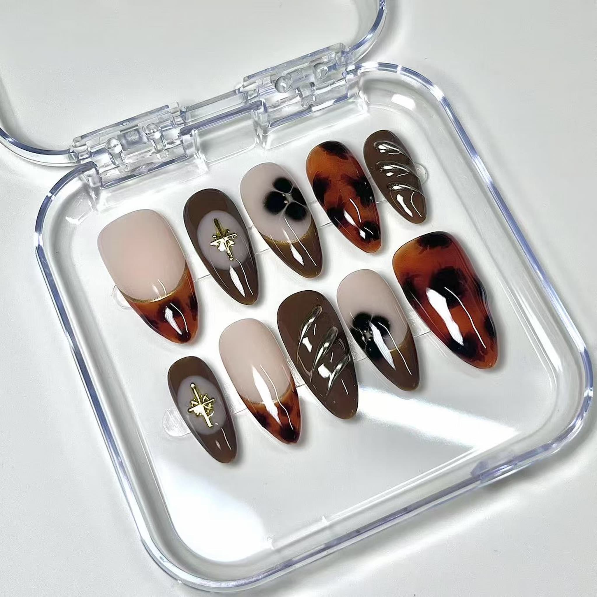 medium length saddle brown almond press on nails with marbled looks