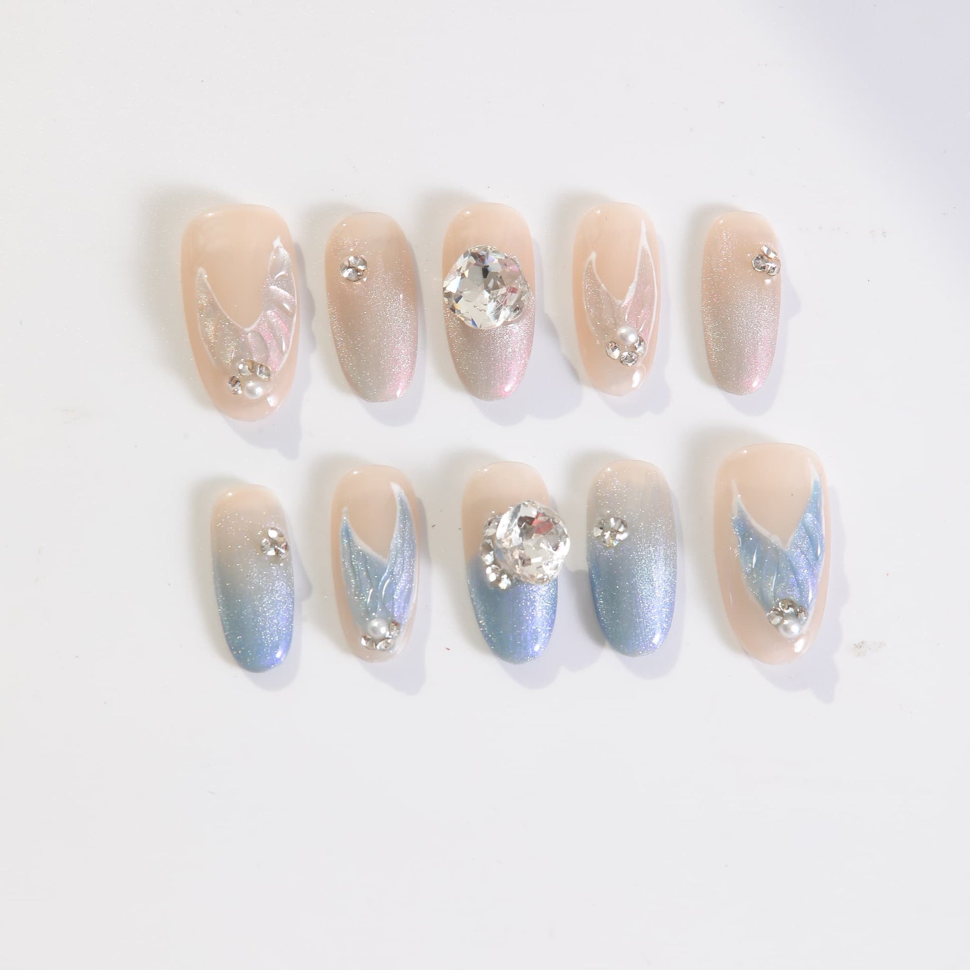 medium length light blue oval press on nails with mermaid tails design and gemstones