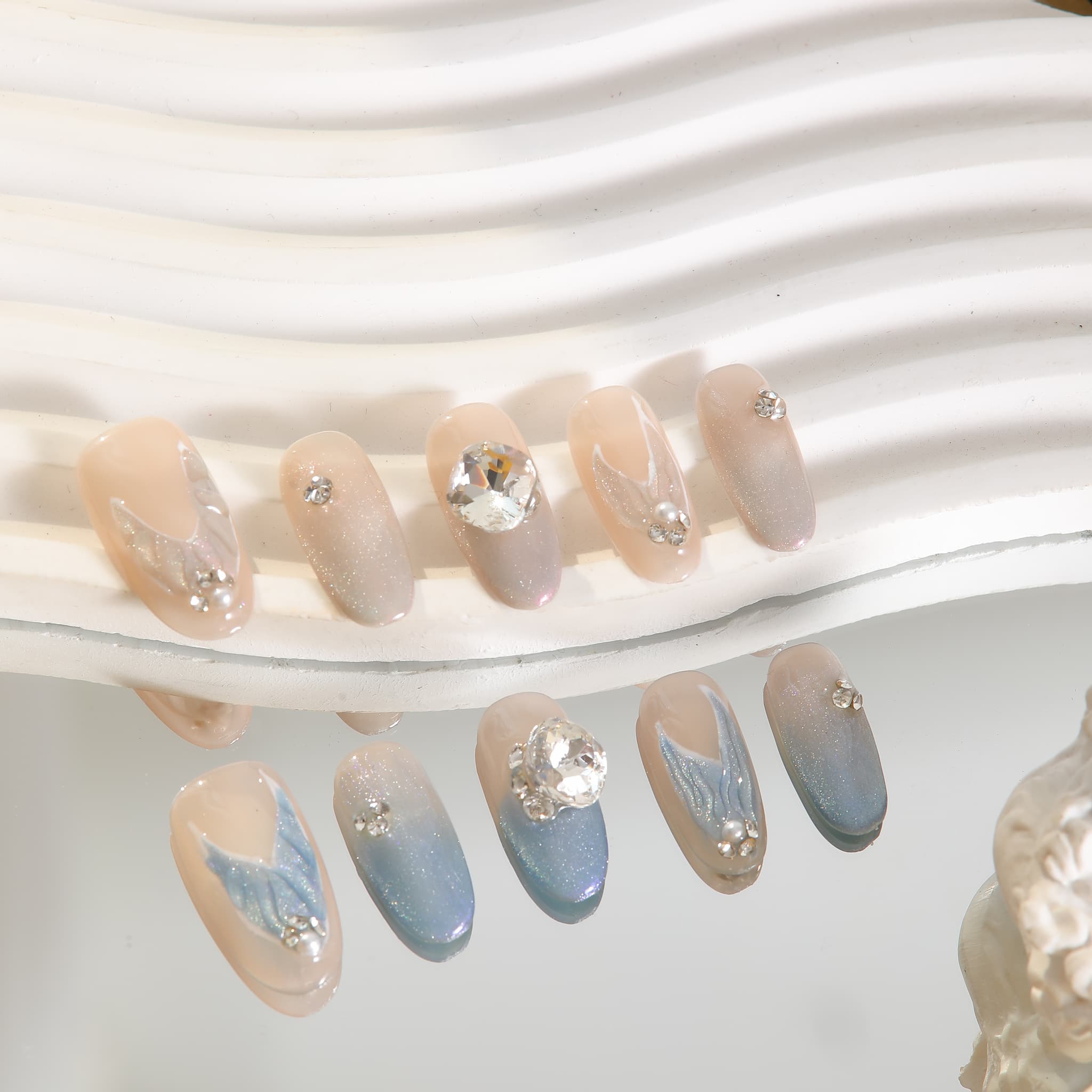 medium length light blue oval press on nails with mermaid tails design and gemstones