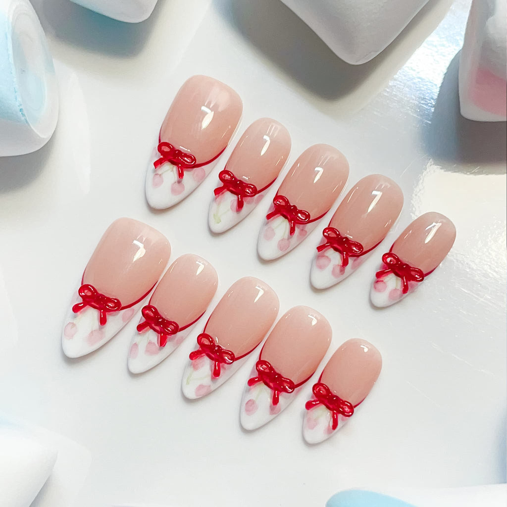 medium length white almond press on nails with cherries and bow design