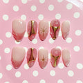 short length misty rose almond press on nails with star design and golden accent