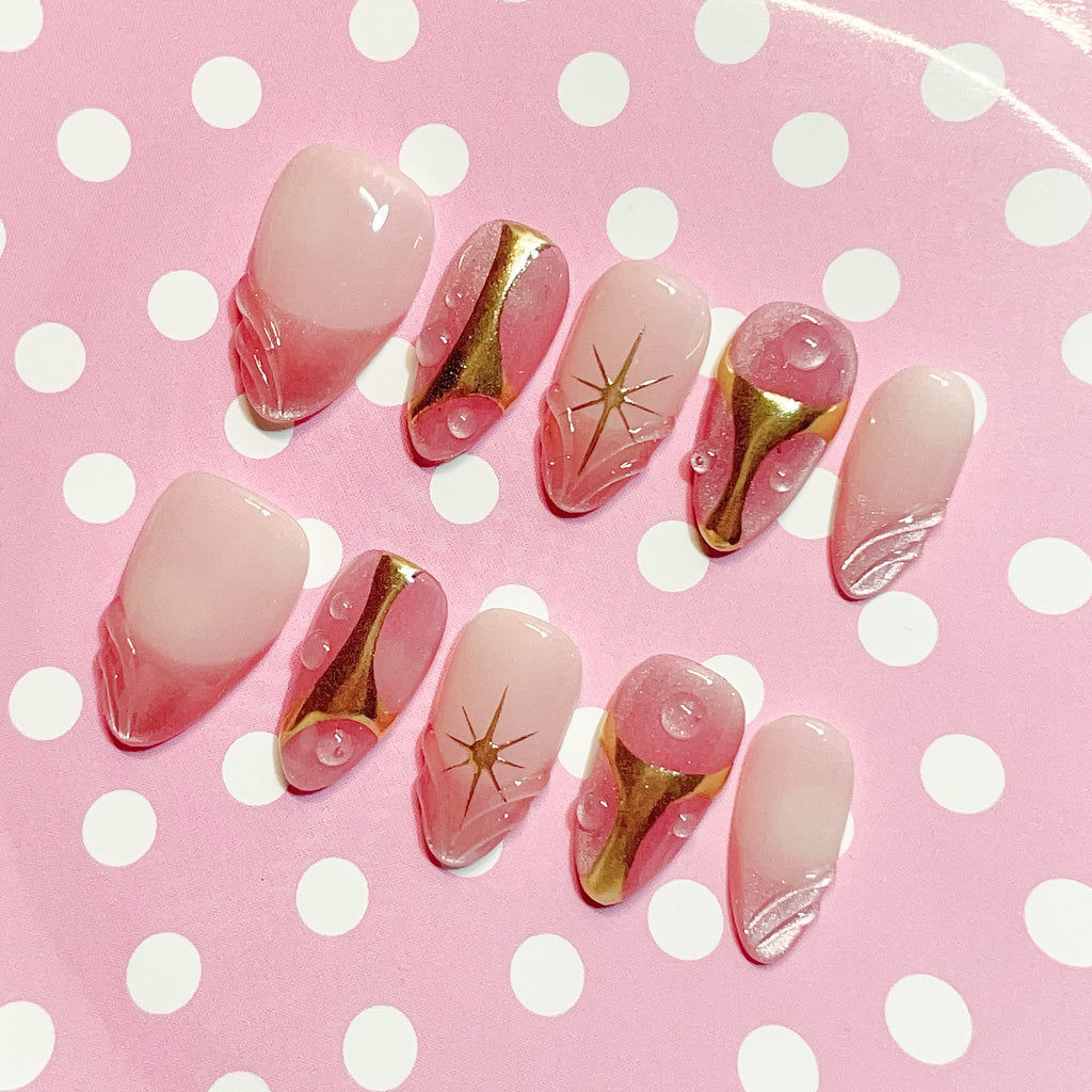 short length misty rose almond press on nails with star design and golden accent