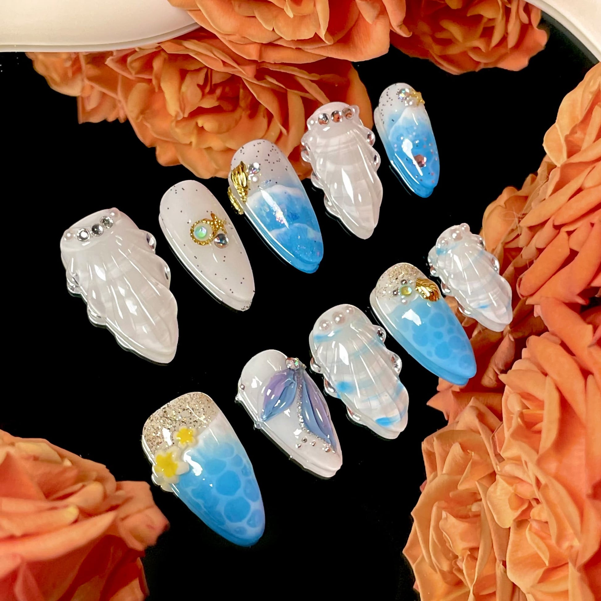 medium length royal blue almond press on nails with seashells design
