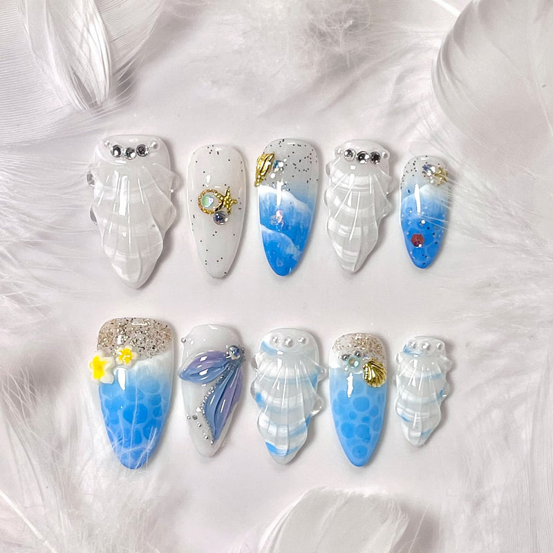 medium length royal blue almond press on nails with seashells design