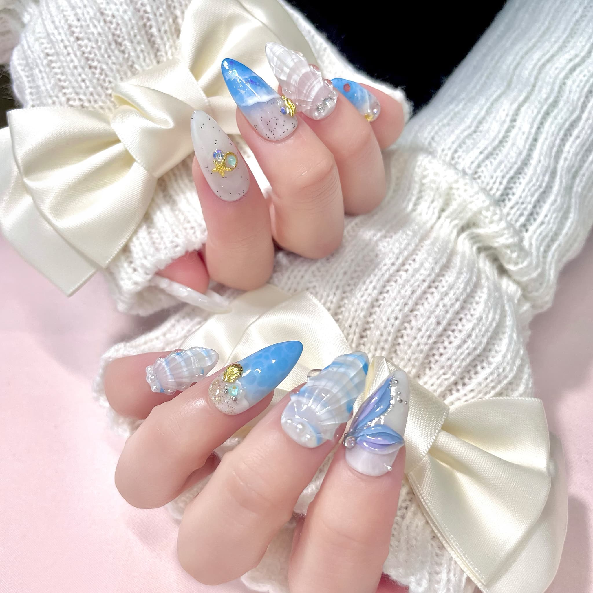medium length royal blue almond press on nails with seashells design
