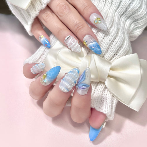 medium length royal blue almond press on nails with seashells design