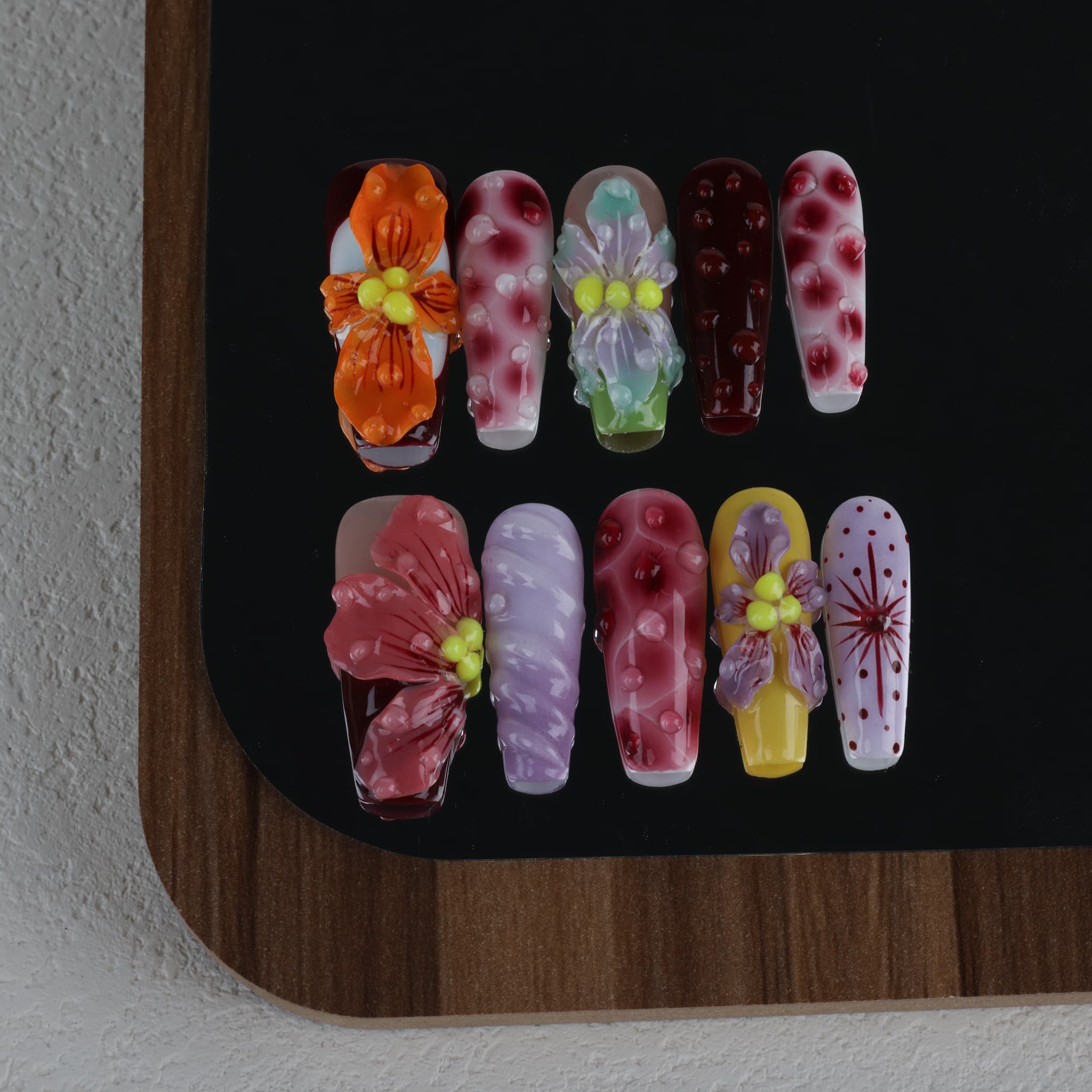 long length rosy brown coffin press on nails with abstract and floral designs. water droplet design
