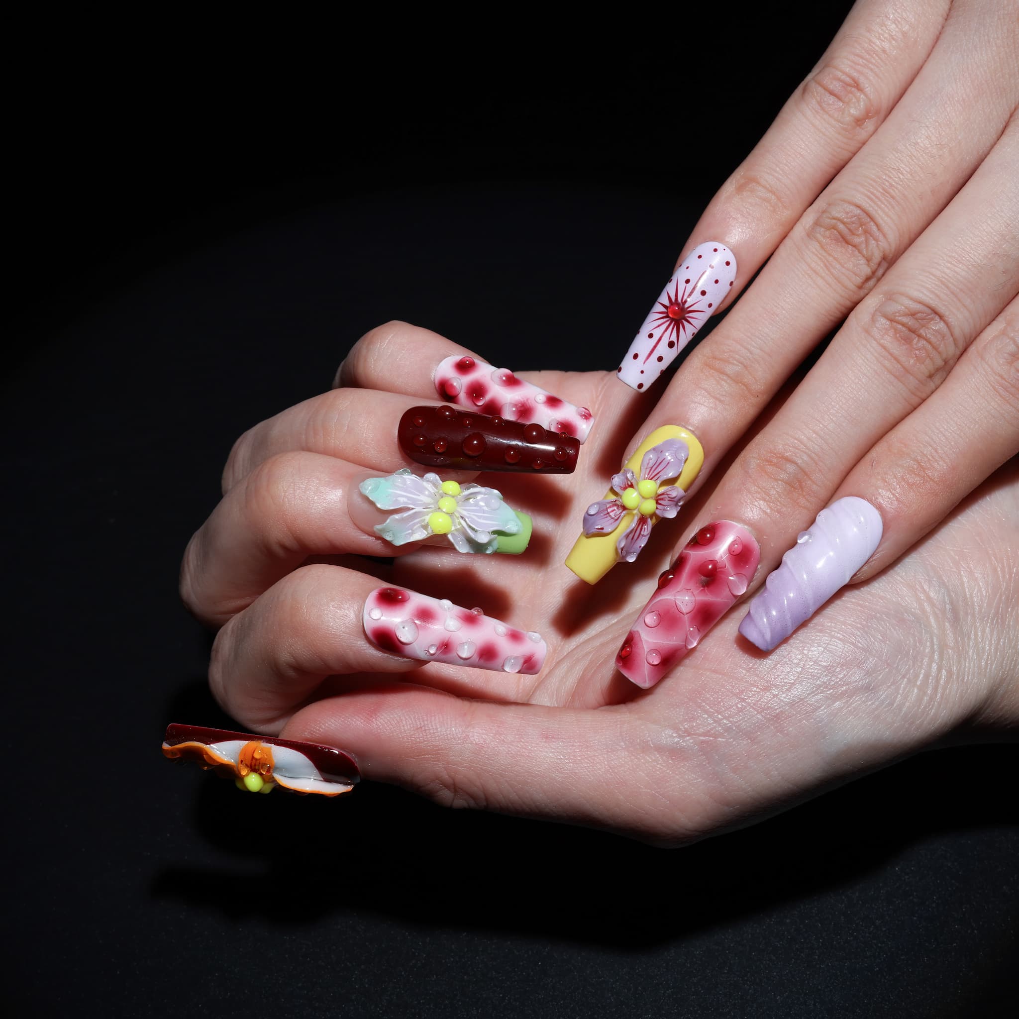 long length rosy brown coffin press on nails with abstract and floral designs. water droplet design