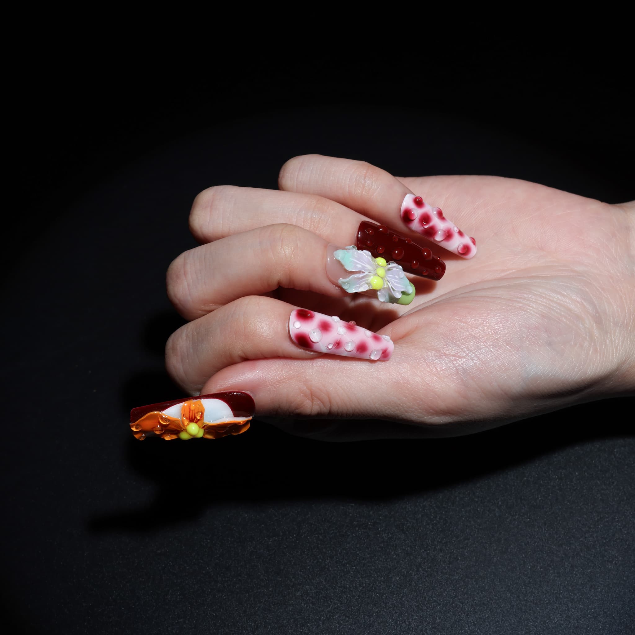 long length rosy brown coffin press on nails with abstract and floral designs. water droplet design