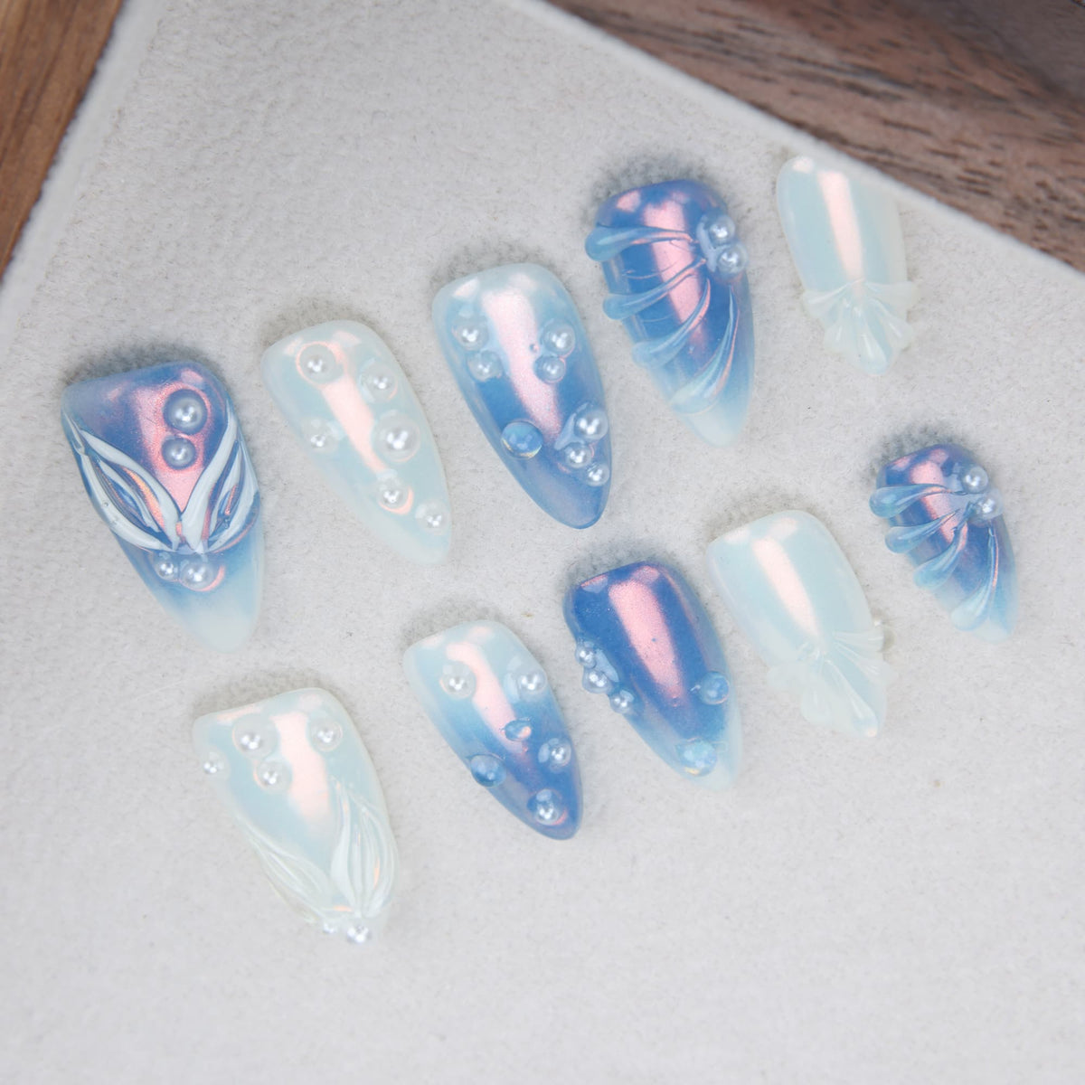 medium length blue almond press on nails with pearls