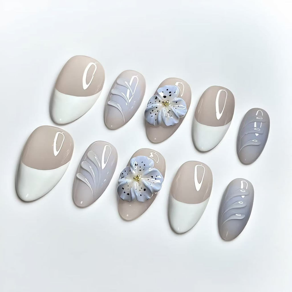 short length nude almond press on nails with french tips and 3d flower design