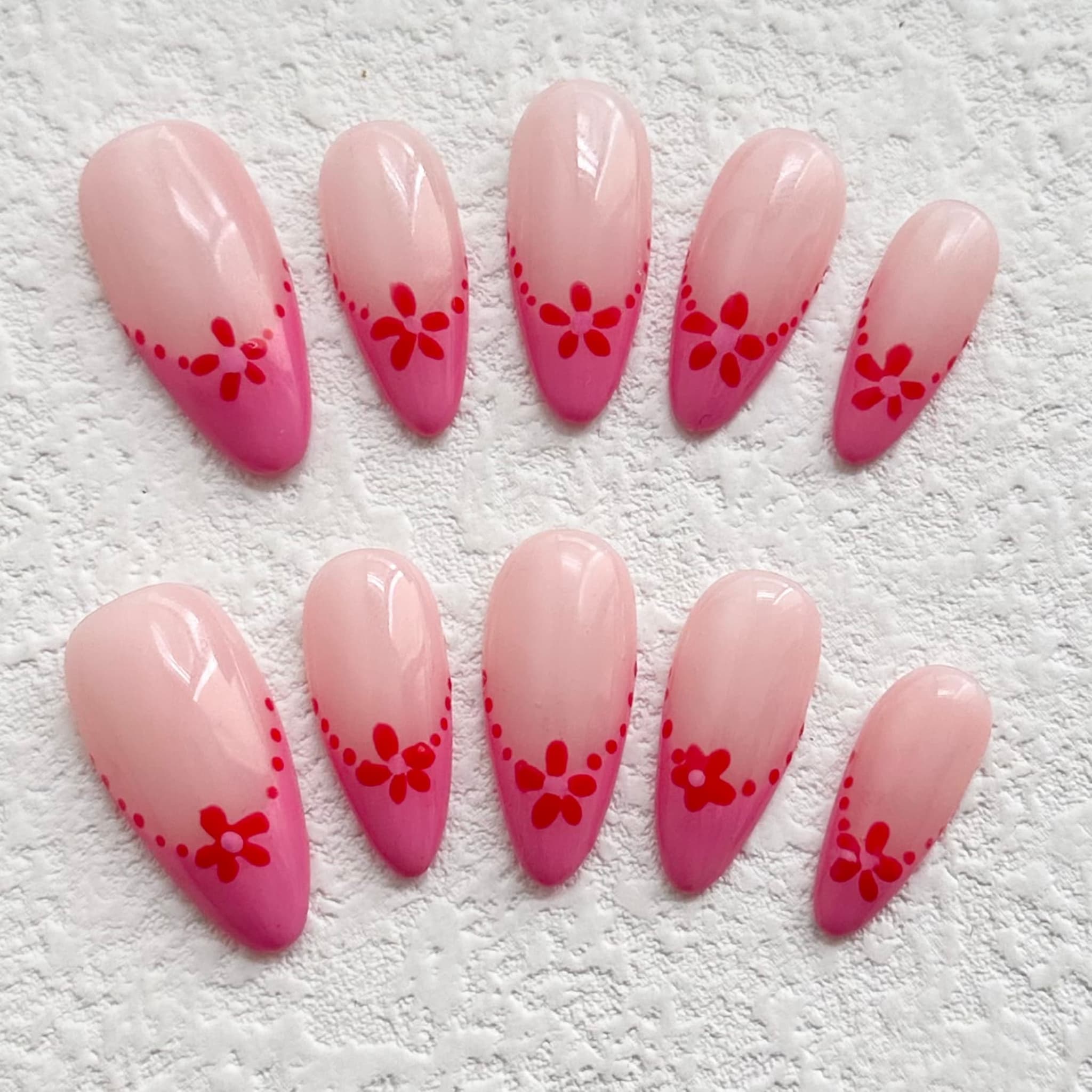 medium deep pink almond press on nails with red petal flower design
