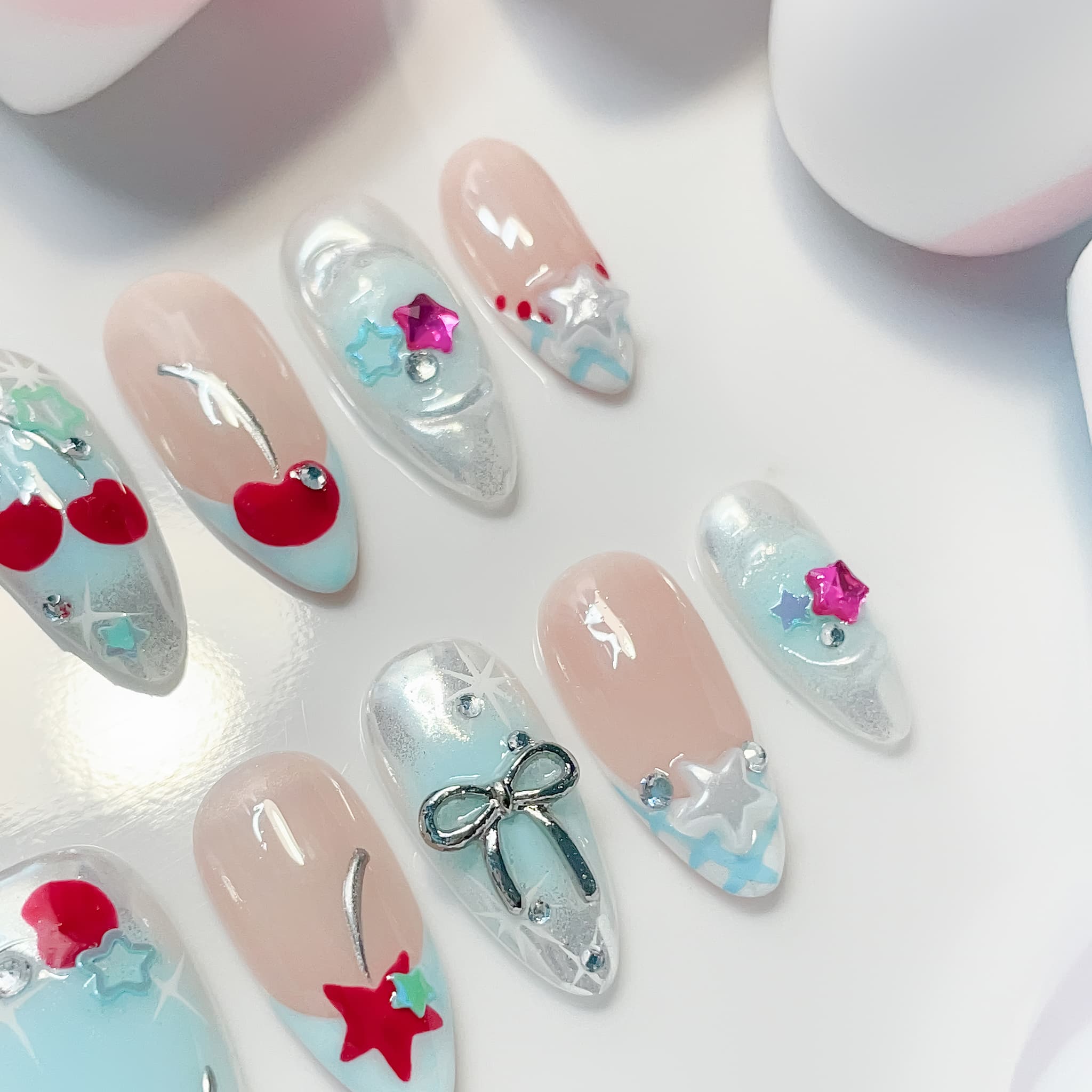 medium length light blue almond press on nails with star and cherries design