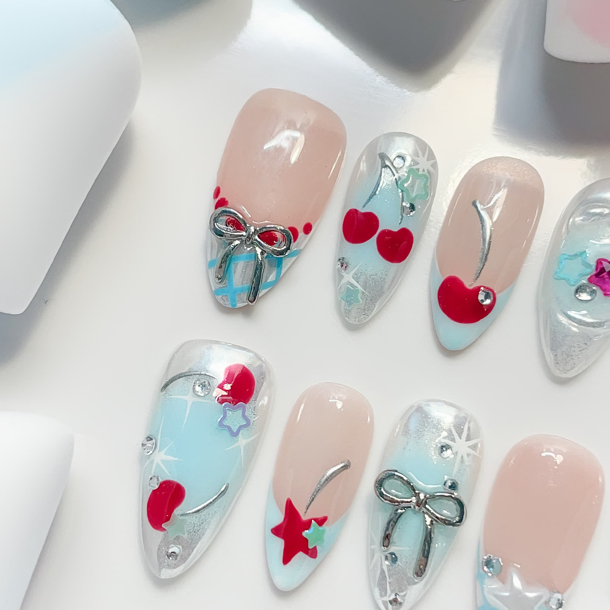 medium length light blue almond press on nails with star and cherries design