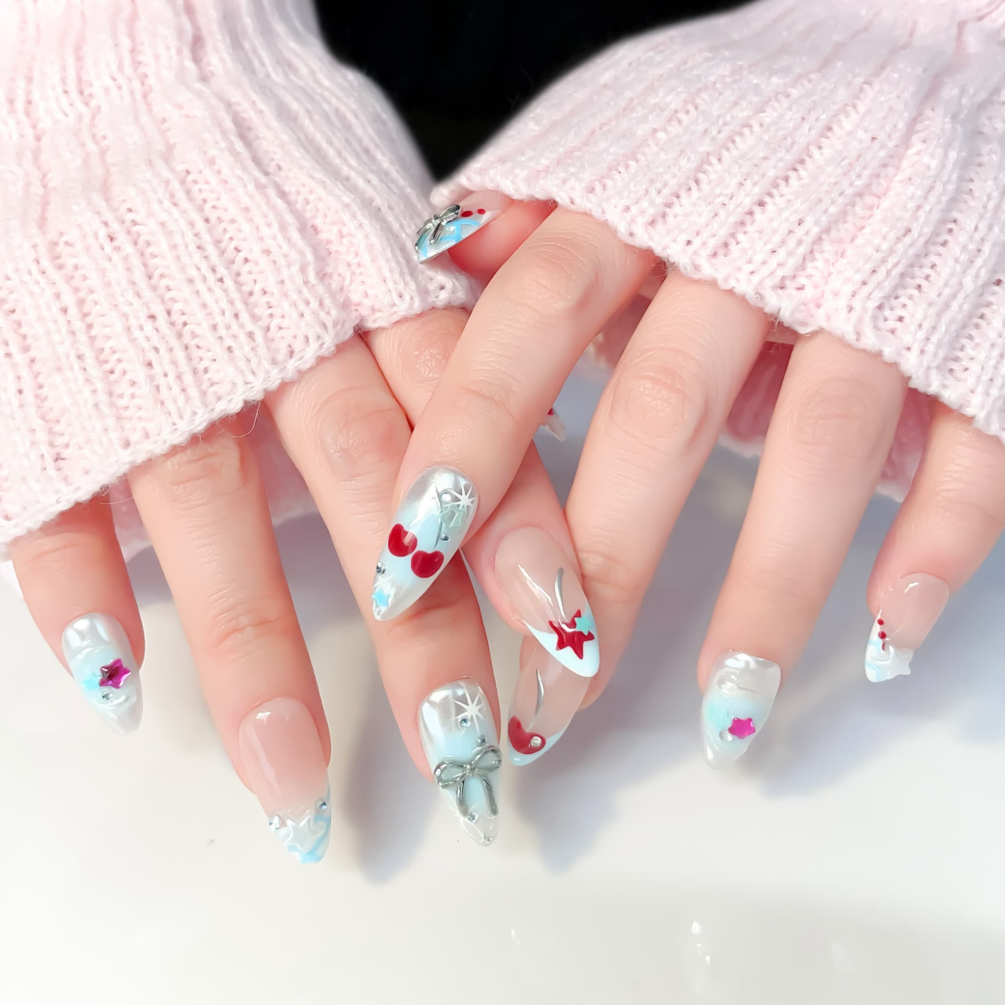 medium length light blue almond press on nails with star and cherries design
