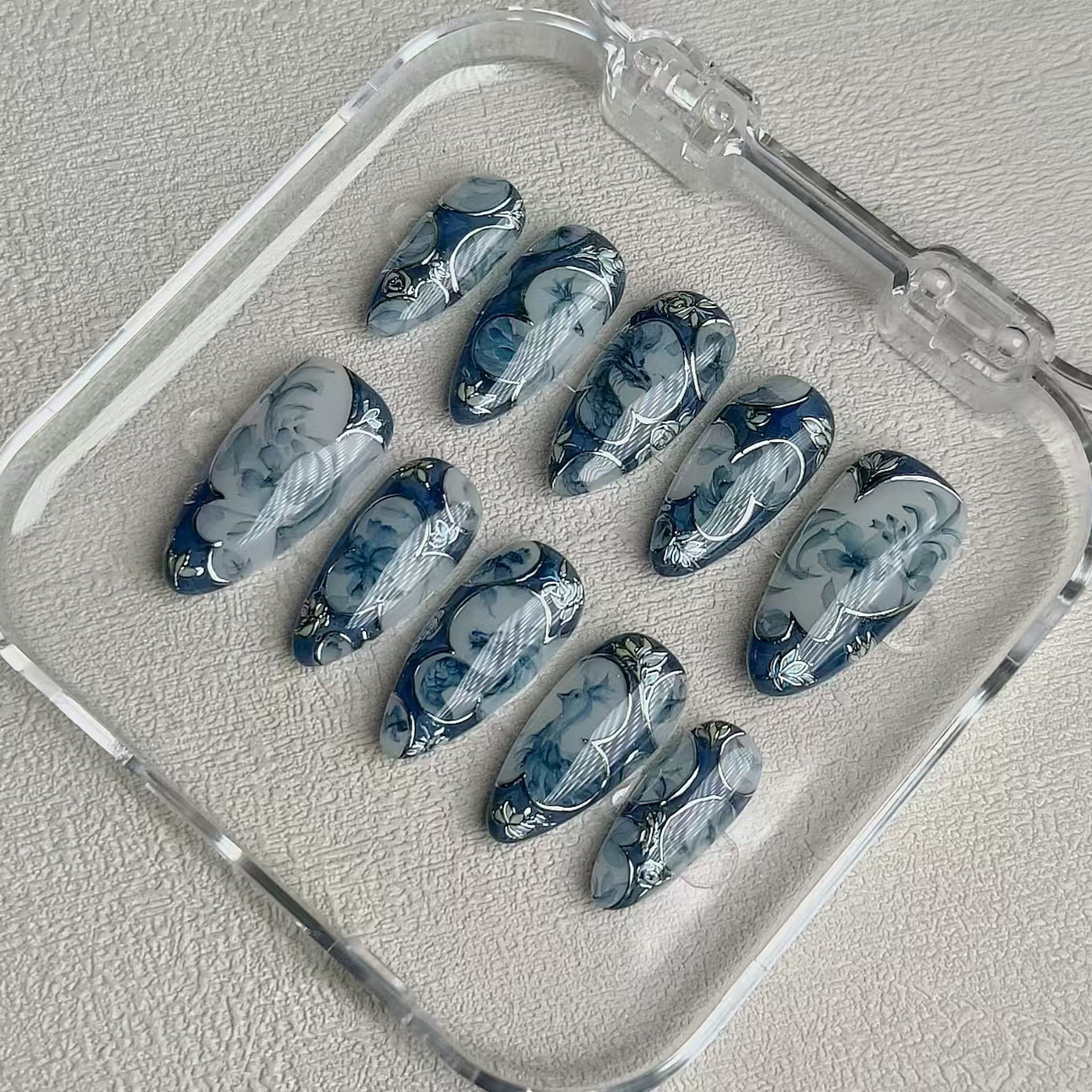 medium length royal blue almond press on nails with porcelain design