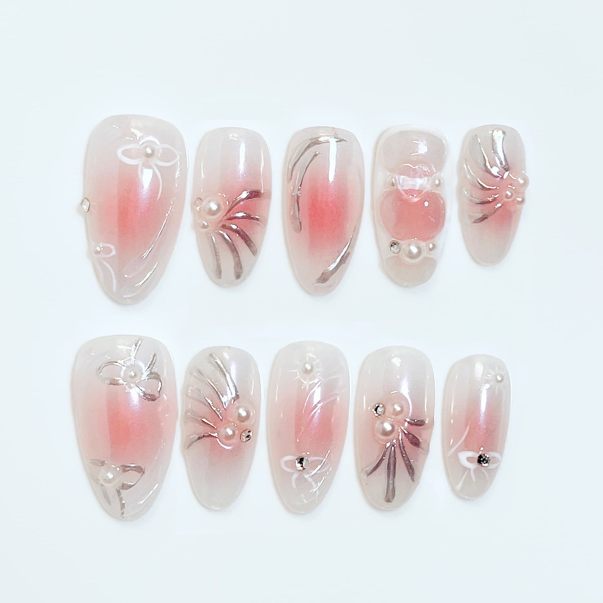 medium length light pink almond press on nails with bow and pearl design