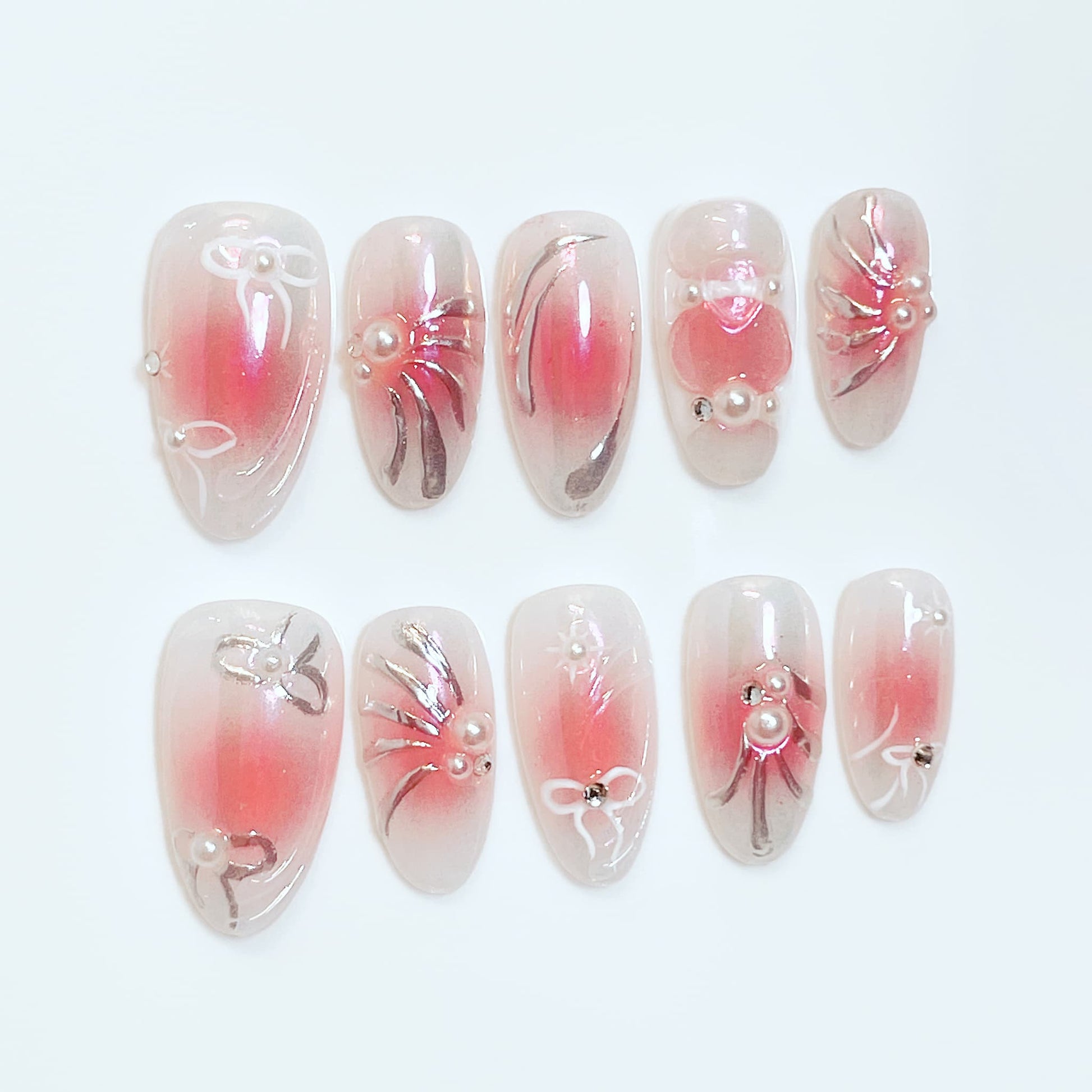 medium length pink almond press on nails with bow and pearl design