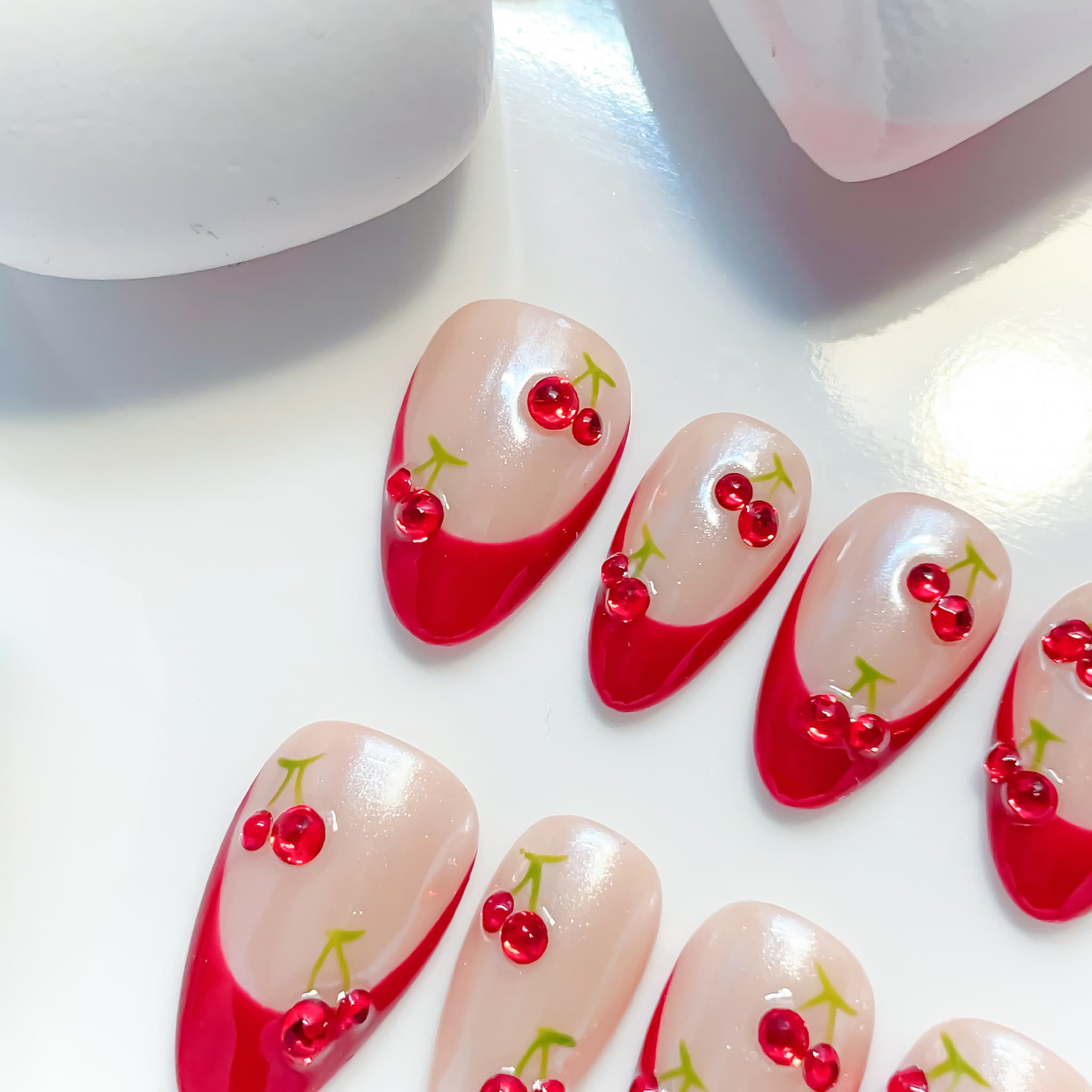 medium length dark red almond press on nails with french tips cherry design