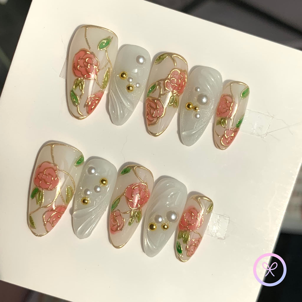 elegant white glossy medium almond press on nails with gilded roses and swirls