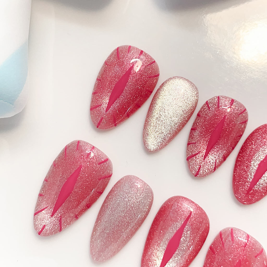 short length red almond press on nails with cat eye design