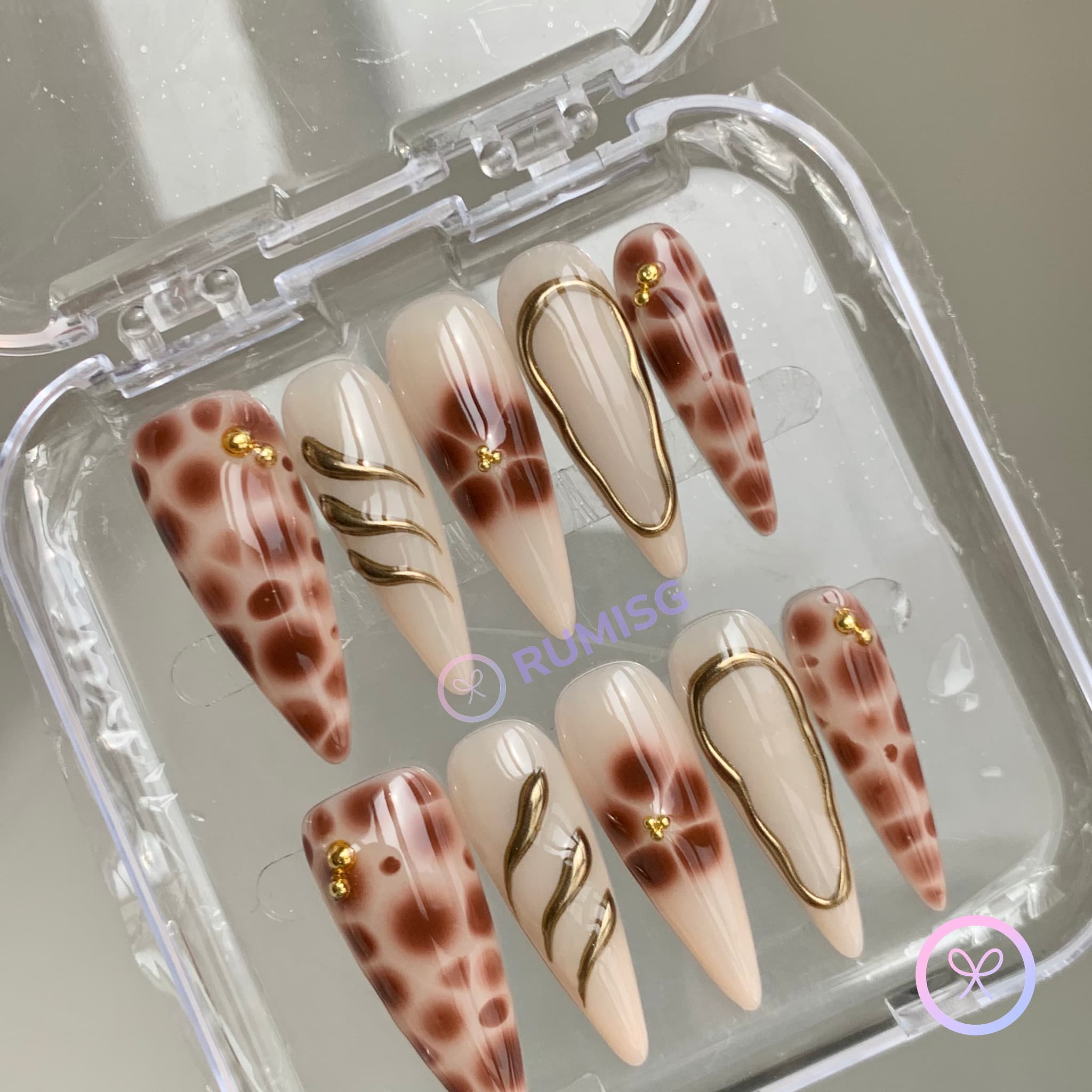 animal print nude glossy long stiletto press on nails with gold swirls and tortoiseshell pattern