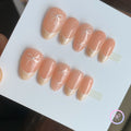 minimalist nude glossy short almond press on nails with mini white bows and lined french tip