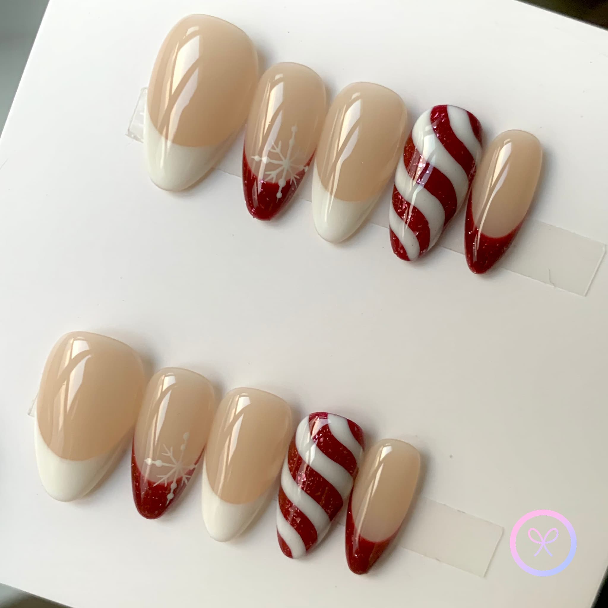 christmas nude glossy short almond press on nails with candy candy swirl and snowflakes