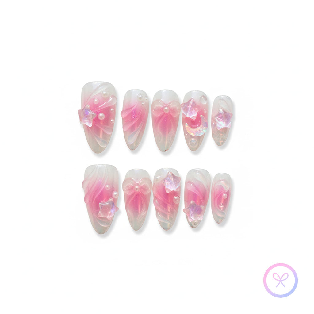 celestial pink glossy medium almond press on nails with star charms and crescent charm