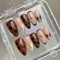 animal print nude glossy medium almond press on nails with gold beads and tortoiseshell