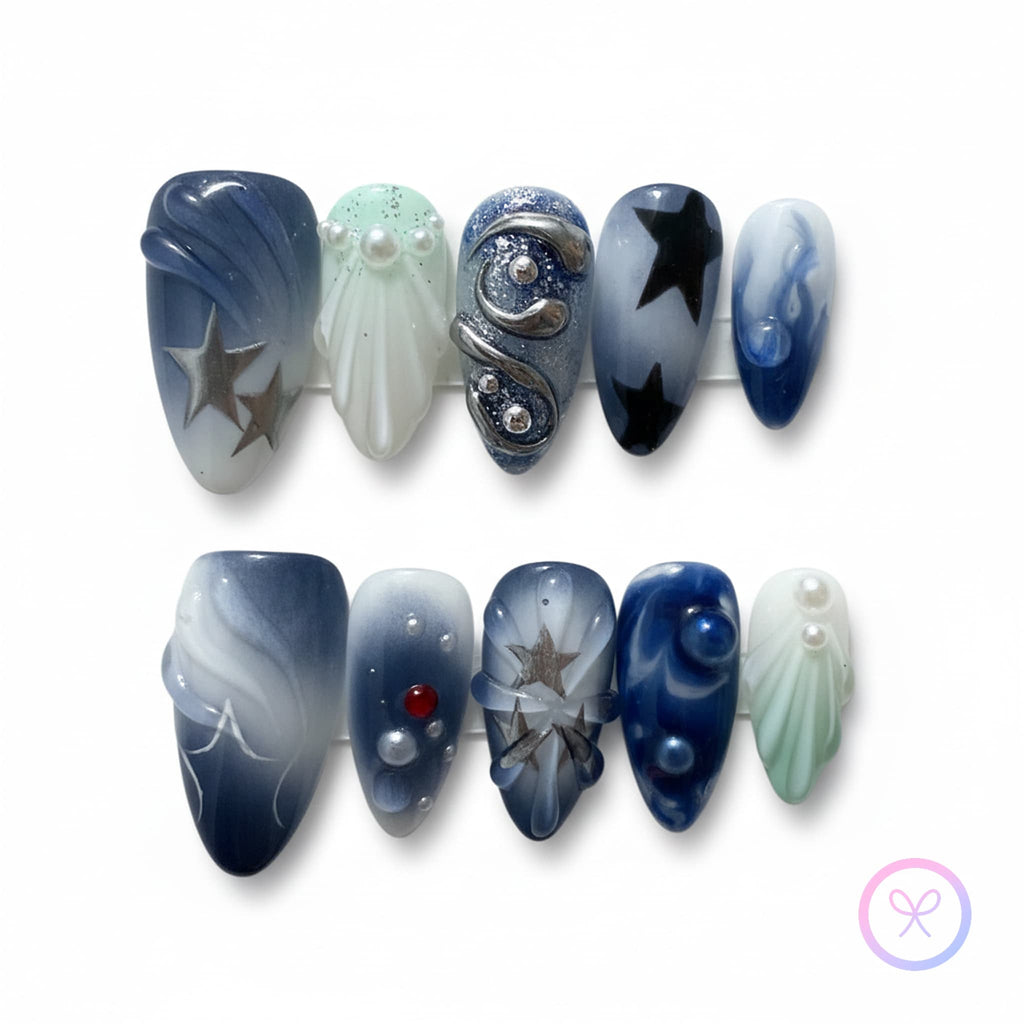 celestial blue glossy medium press on nails with celestial motifs and metallic swirls and stars