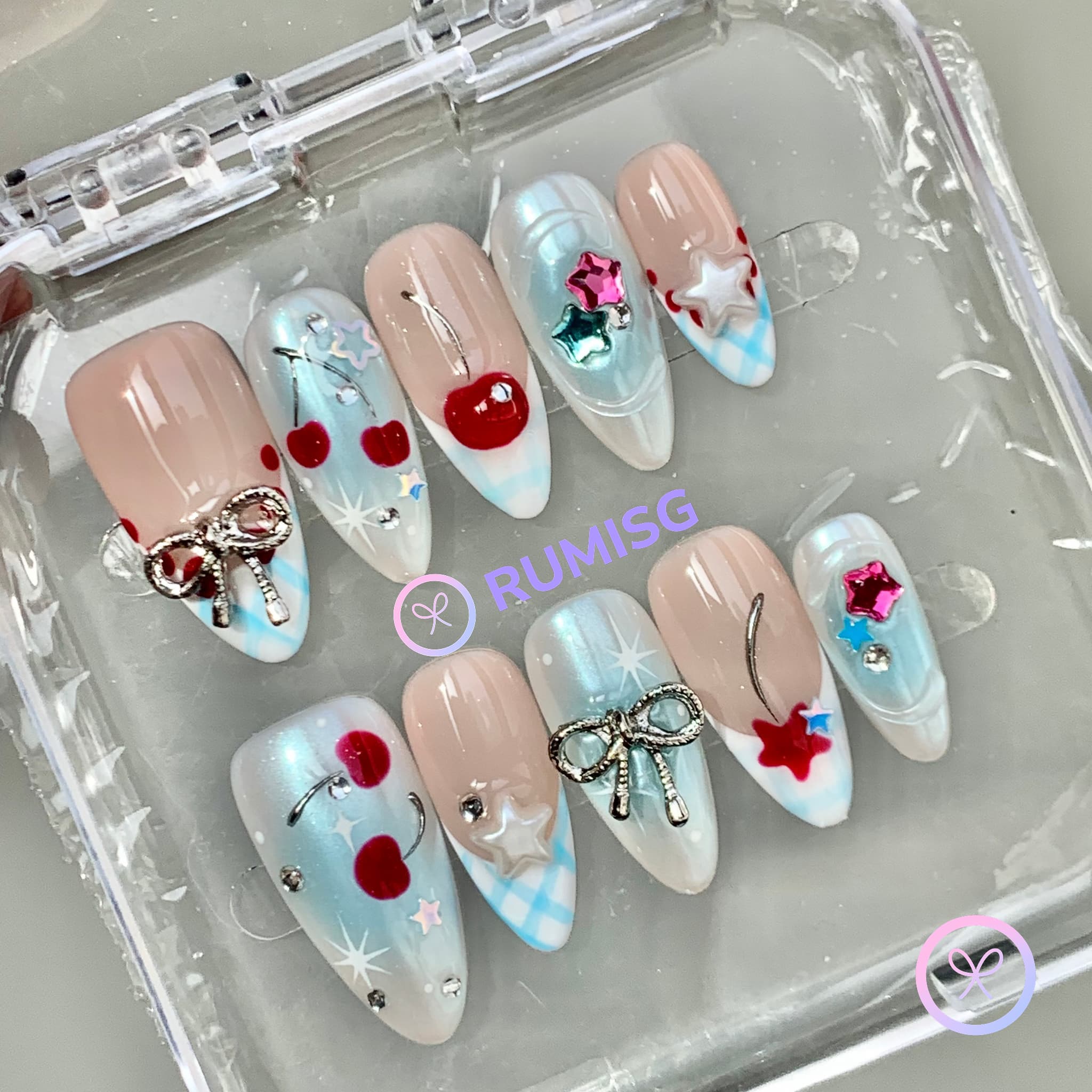 fruitcore cyan glossy medium almond press on nails with cherry and bow charm