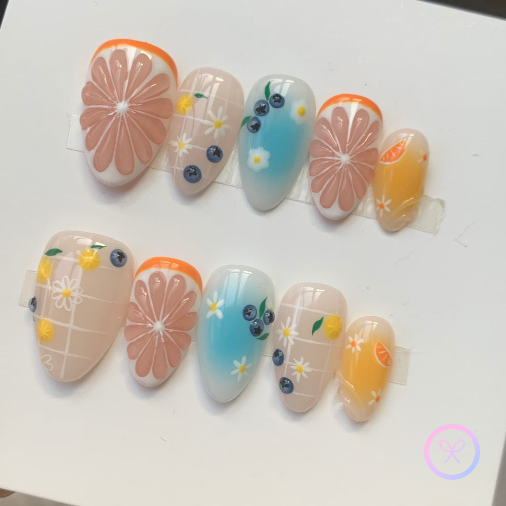 fruitcore orange glossy short almond press on nails with citrus and blueberry and lemons and orange slices and daisy
