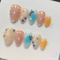 fruitcore orange glossy short almond press on nails with citrus and blueberry and lemons and orange slices and daisy