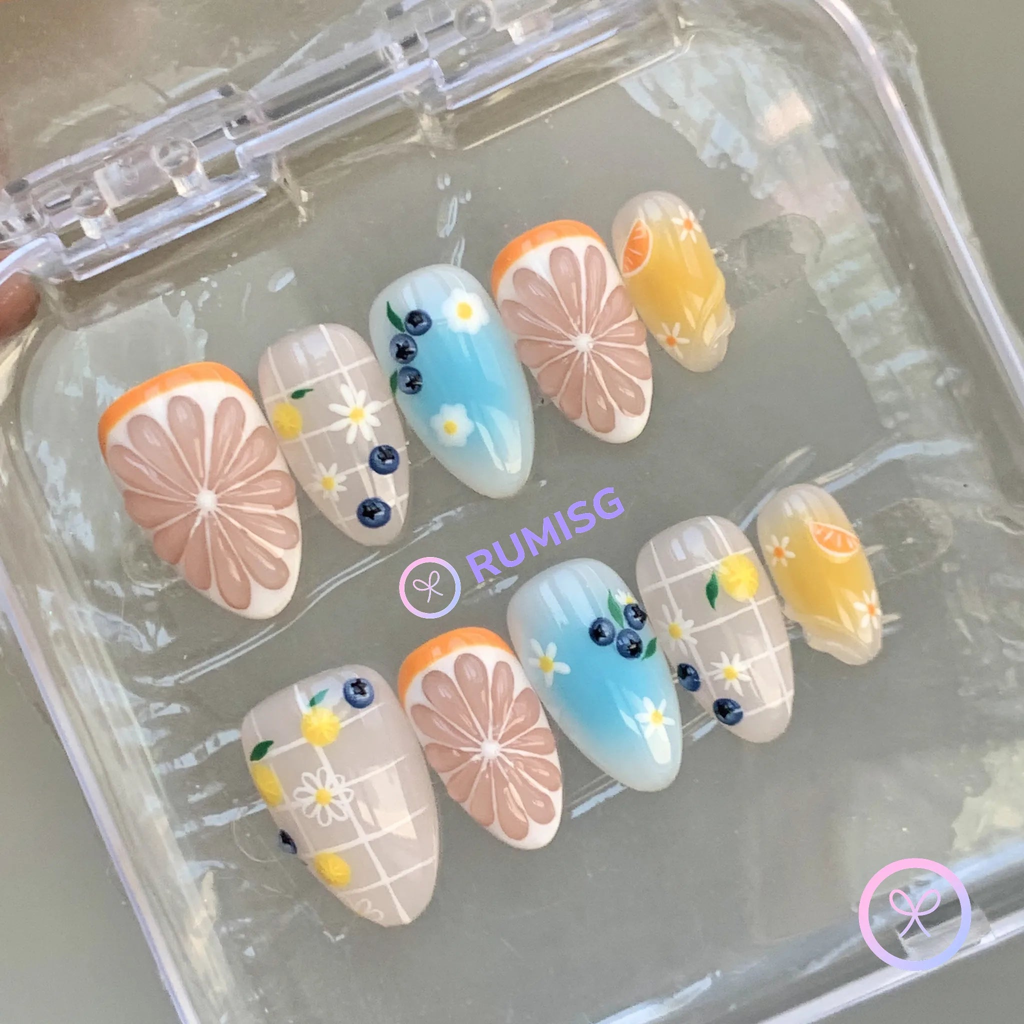 fruitcore orange glossy short almond press on nails with citrus slice and daisy
