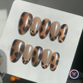 animal print nude glossy medium oval press on nails with glitter and leopard print