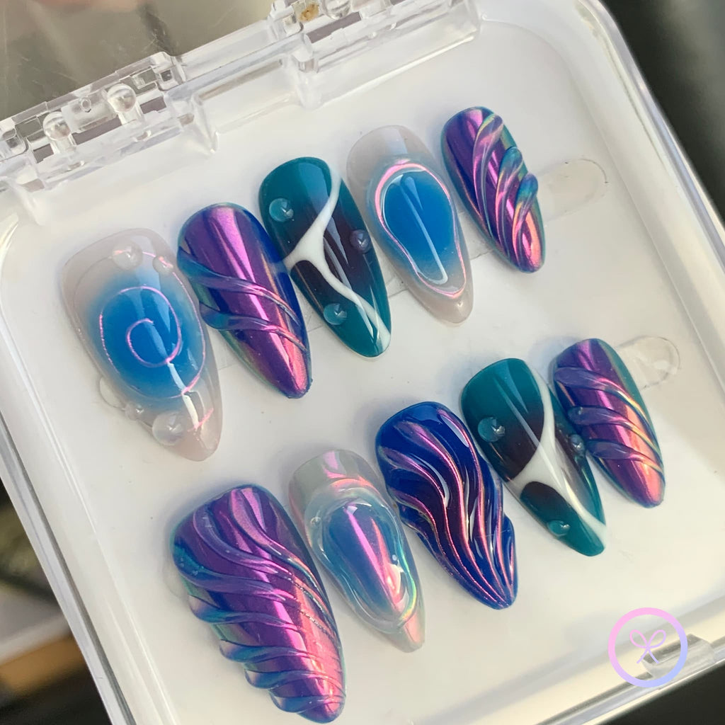 elegant purple iridescent medium almond press on nails with detailing and swirls and spirals and water droplets motif