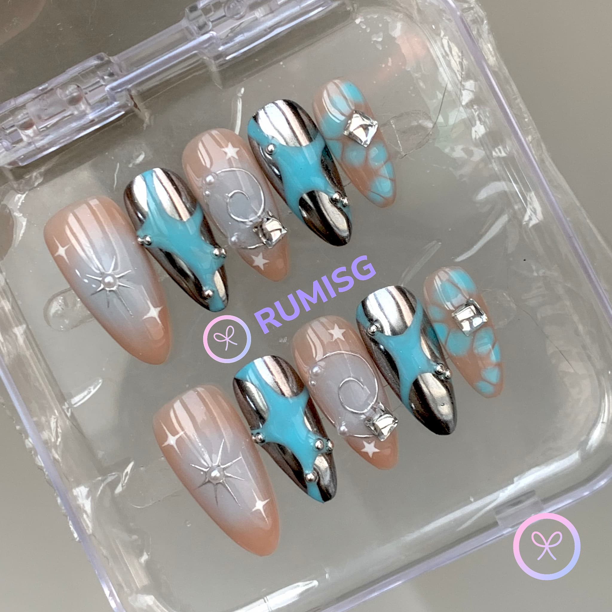 celestial cyan glossy medium almond press on nails with starburst and bloomscales
