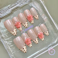 cute nude glossy medium almond press on nails with polka dot french tip and 3d flower
