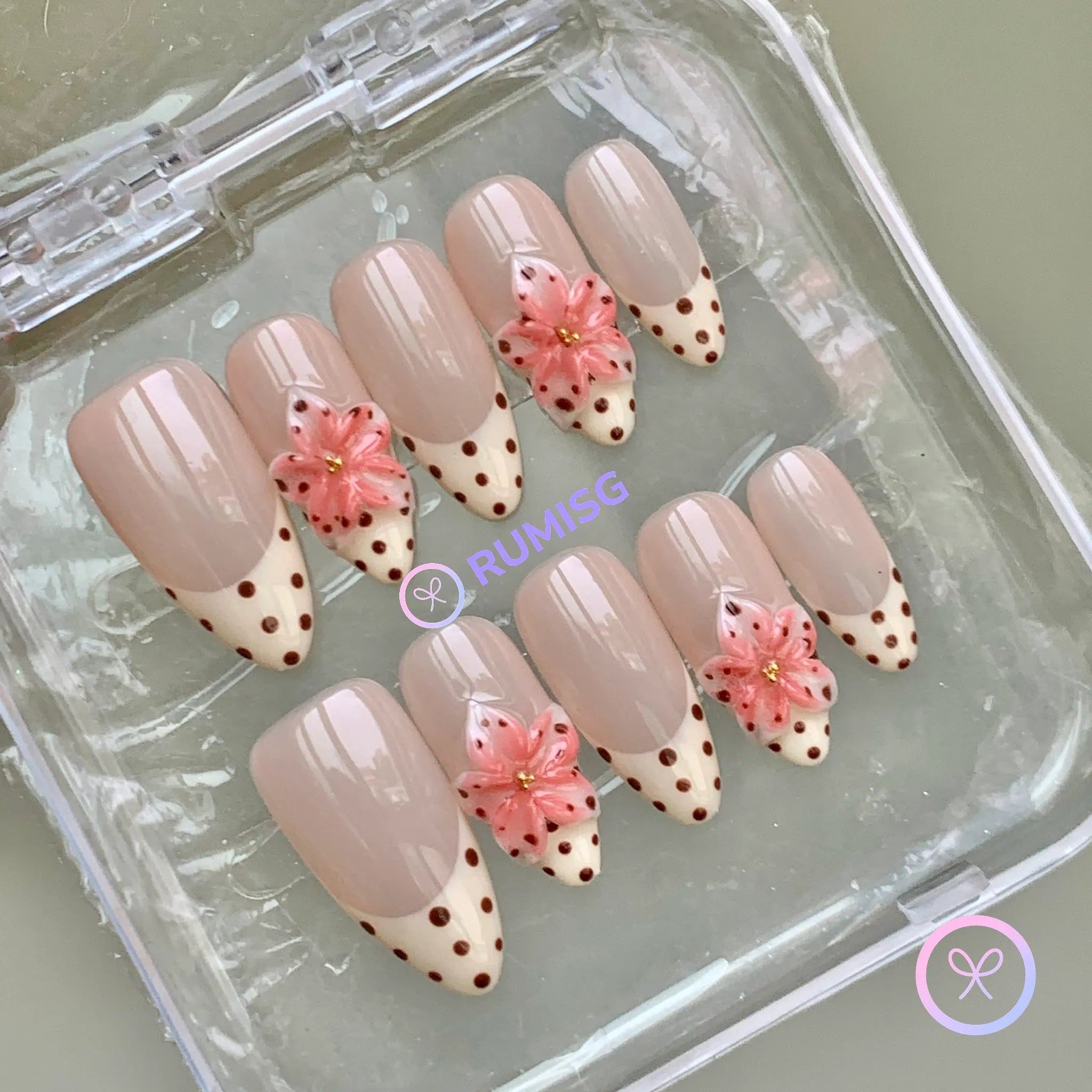 cute nude glossy medium almond press on nails with polka dot french tip and 3d flower