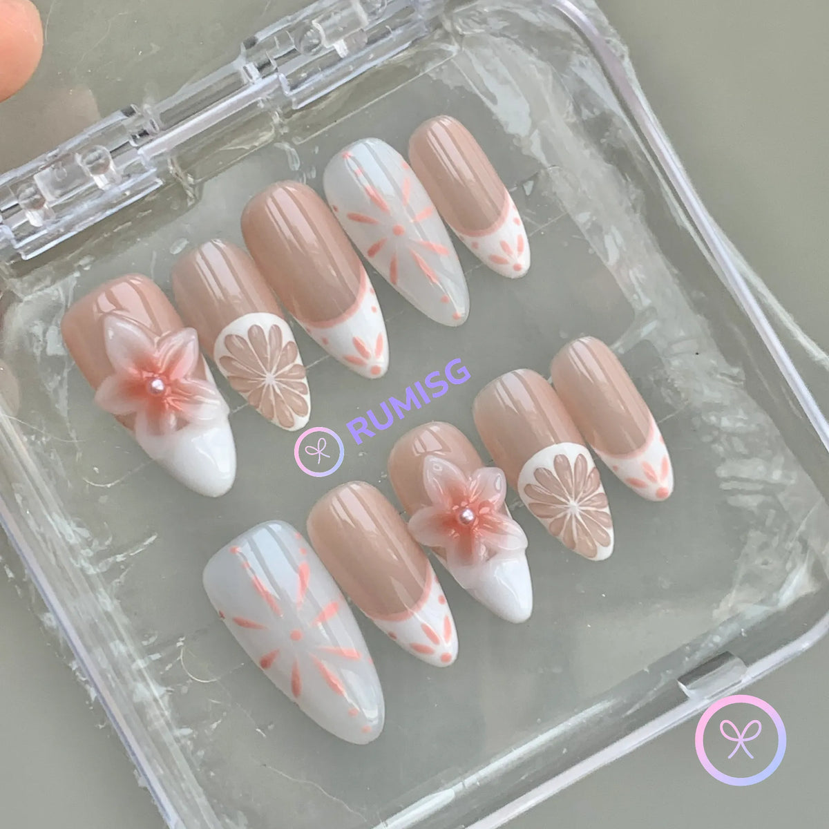 elegant nude glossy medium almond press on nails with mediterranean tile linework and 3d flower