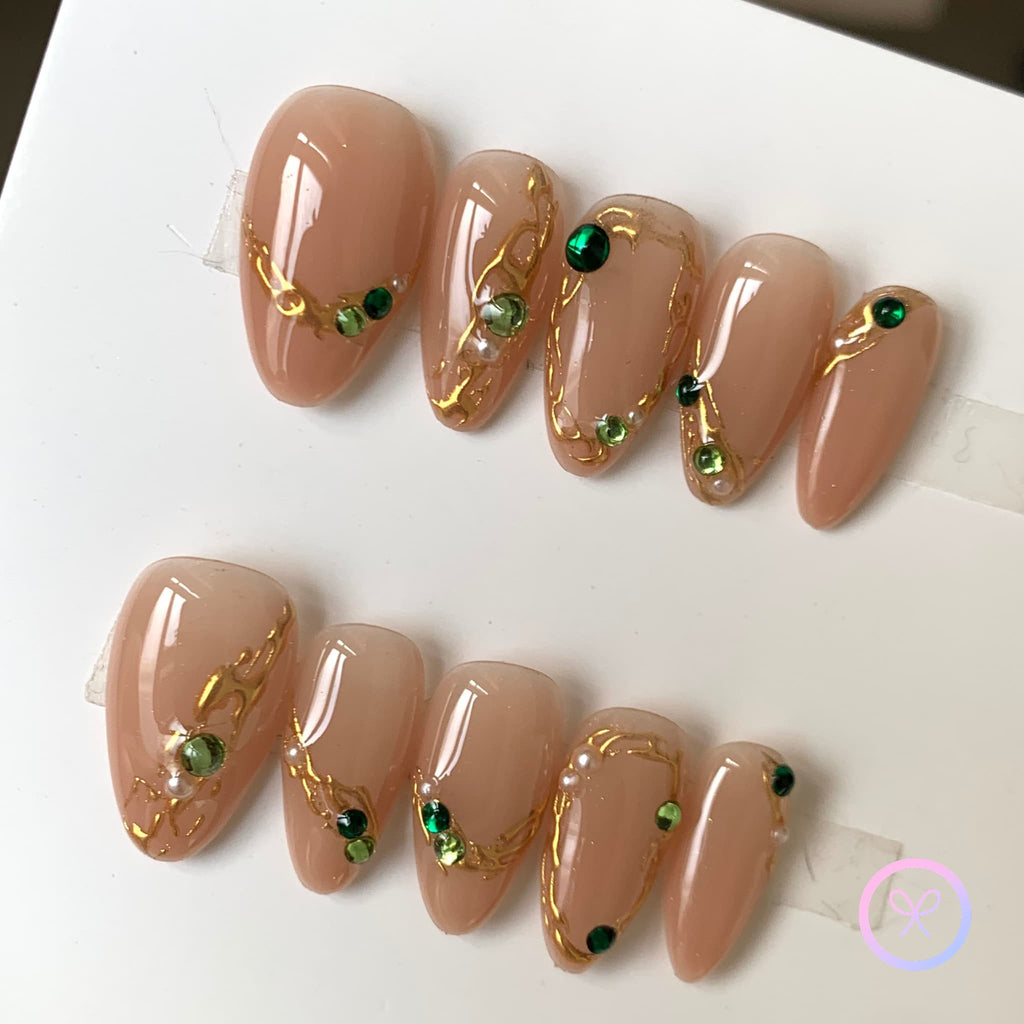 elegant nude glossy short almond press on nails with filigree and emerald gemstones