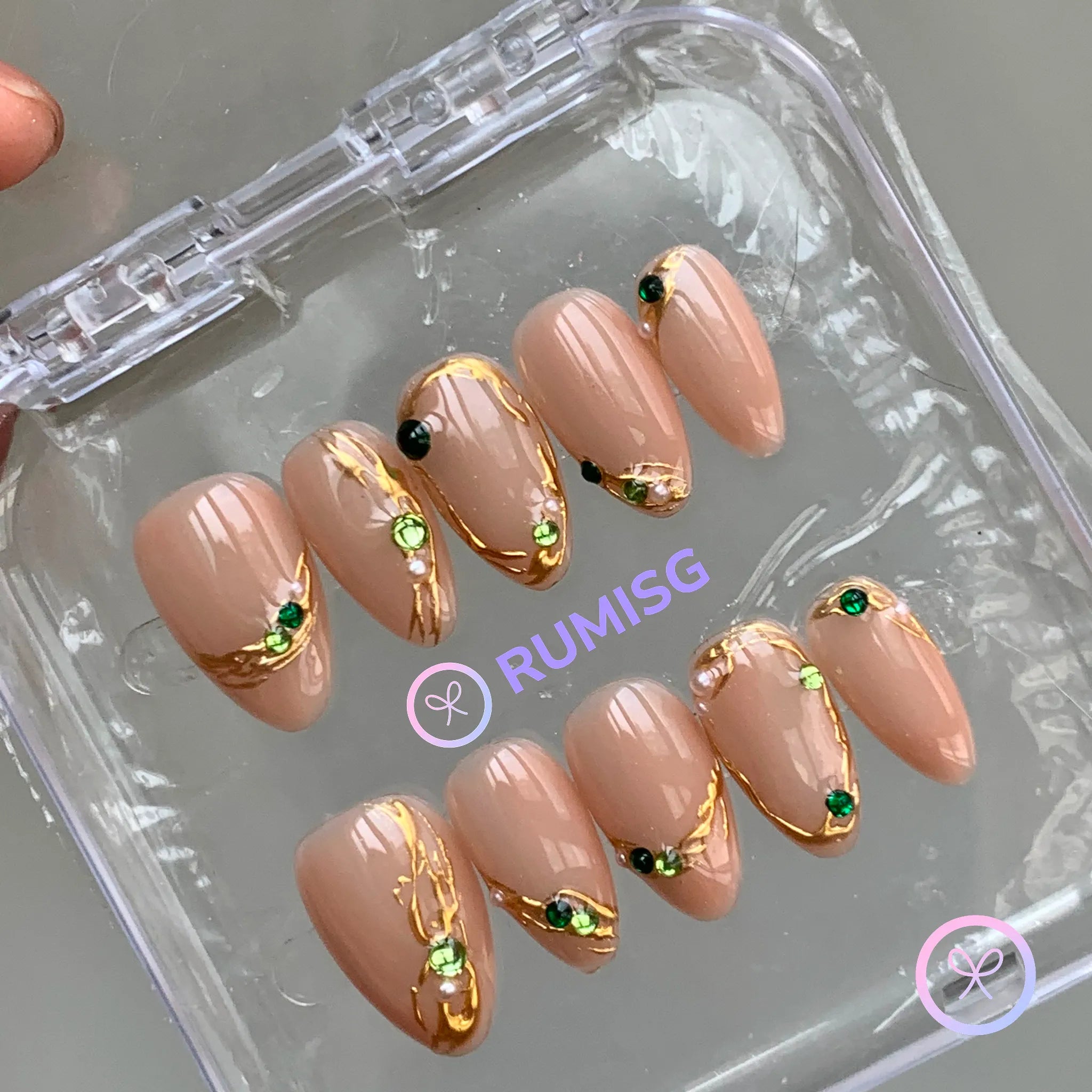  elegant nude glossy short almond press on nails with gold filigree and emerald rhinestone