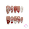 romantic nude glossy medium almond press on nails with 3d flower motifs and summer aesthetic