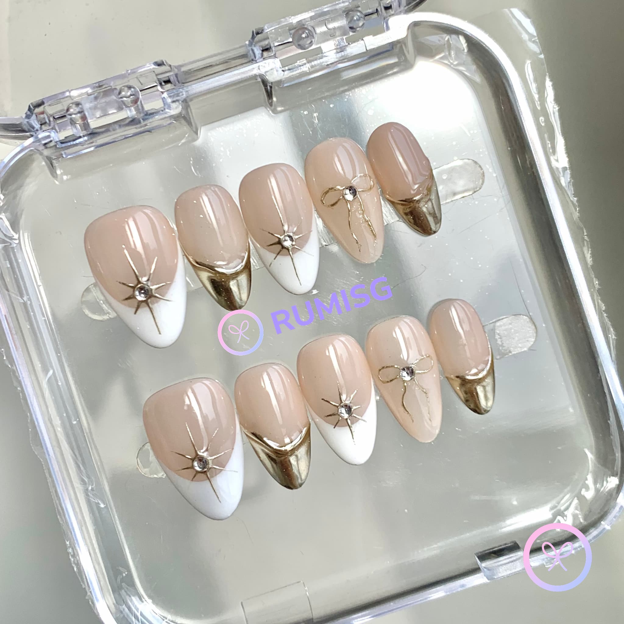 elegant nude glossy short almond press on nails with gold french tip and golden bow
