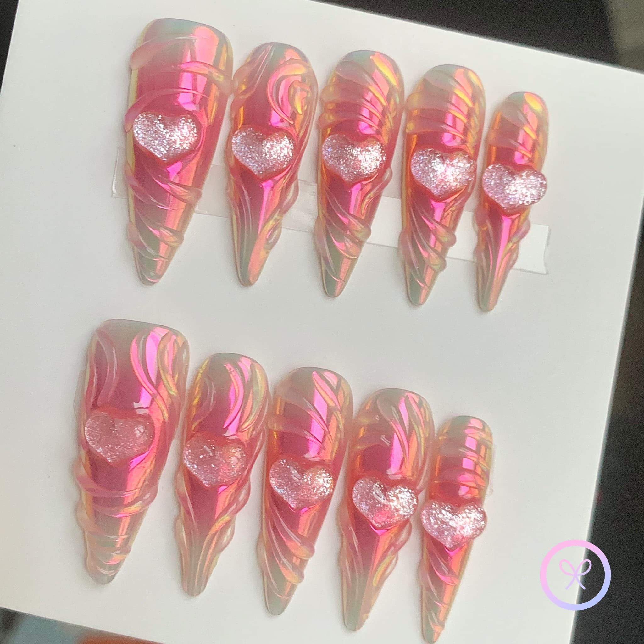y2k pink iridescent long stiletto press on nails with heart charms and swirls and blush